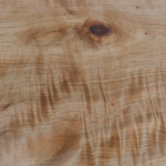 Figured maple wood fireplace mantel feature